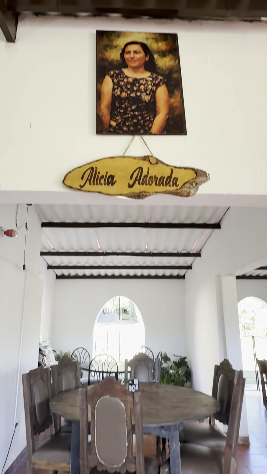 Interior del salón Alicia Adorada con mesas de hierro forjado